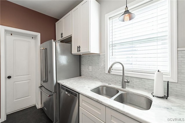 1815 Seddon Rd, Richmond, VA 23227 - kitchen featuring appliances with stainless steel finishes, white cabinets, tasteful backsplash, pendant lighting, and light stone countertops