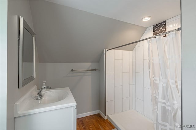 1815 Seddon Rd, Richmond, VA 23227 - bathroom with lofted ceiling, vanity, a tile shower, and wood finished floors