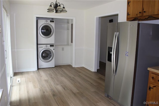 5041 Oakforest Dr, Chesterfield, VA 23832 - laundry room with stacked washer / dryer, a chandelier, and light wood-style flooring