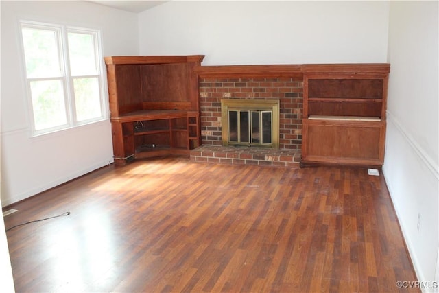 5041 Oakforest Dr, Chesterfield, VA 23832 - unfurnished living room featuring wood finished floors, baseboards, and a brick fireplace