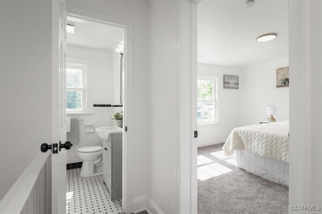 215 S S St, Petersburg, VA 23803 - bedroom with ensuite bath, a sink, and baseboards