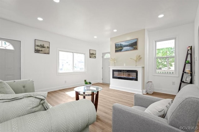 215 S S St, Petersburg, VA 23803 - living area featuring healthy amount of natural light, recessed lighting, baseboards, light wood-style flooring, and a glass covered fireplace