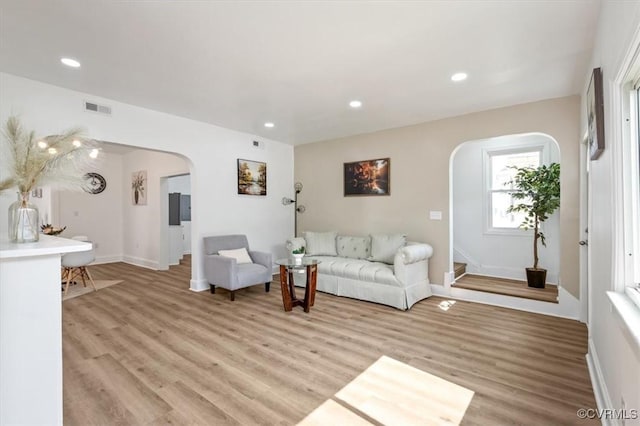 215 S S St, Petersburg, VA 23803 - living area featuring arched walkways, light wood finished floors, baseboards, and recessed lighting
