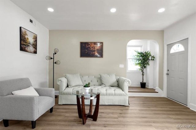 215 S S St, Petersburg, VA 23803 - living room featuring arched walkways, recessed lighting, light wood-type flooring, and baseboards