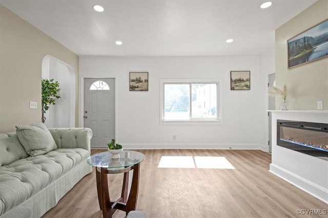 215 S S St, Petersburg, VA 23803 - living area featuring wood finished floors, arched walkways, recessed lighting, baseboards, and a glass covered fireplace