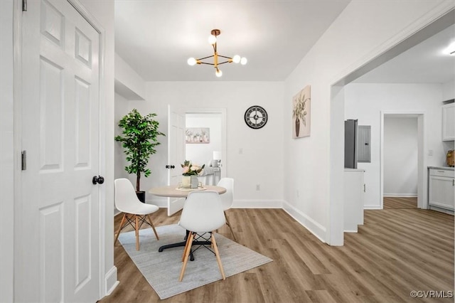 215 S S St, Petersburg, VA 23803 - dining room featuring a chandelier, light wood-style flooring, and baseboards