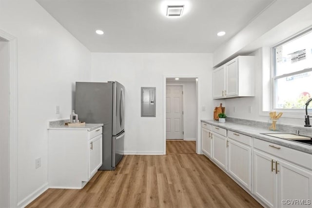 215 S S St, Petersburg, VA 23803 - kitchen featuring freestanding refrigerator, a sink, light wood-type flooring, electric panel, and recessed lighting