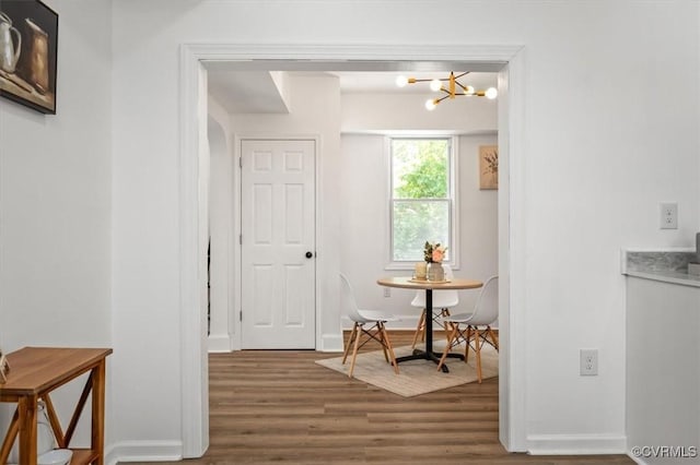 215 S S St, Petersburg, VA 23803 - dining area featuring wood finished floors, a chandelier, and baseboards