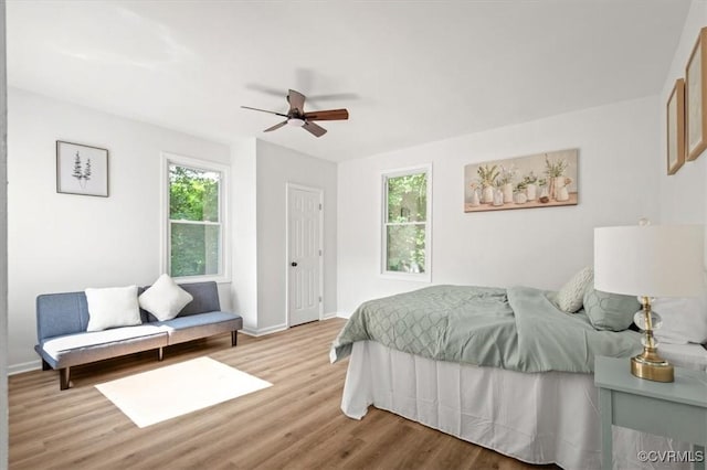 215 S S St, Petersburg, VA 23803 - bedroom with light wood finished floors, multiple windows, and baseboards