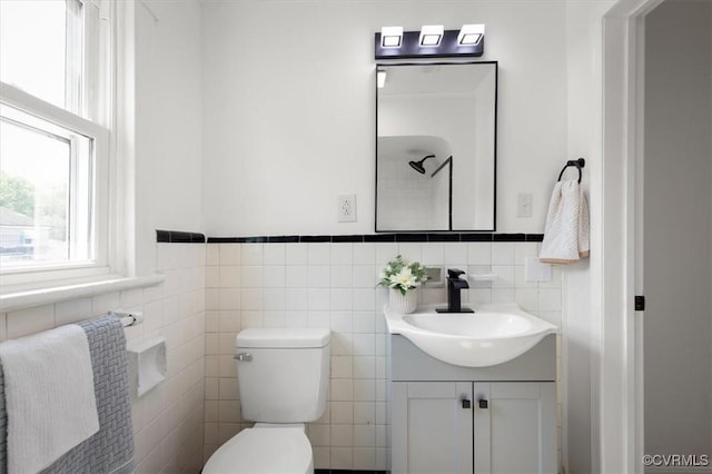 215 S S St, Petersburg, VA 23803 - bathroom with vanity, toilet, tile walls, and wainscoting