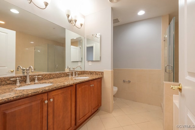 6 N 6th St Unit U3C, Richmond, VA 23219 - bathroom featuring a stall shower, double vanity, tile patterned flooring, toilet, and tile walls