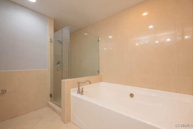 6 N 6th St Unit U3C, Richmond, VA 23219 - full bath with tile walls, a bath, a shower stall, tile patterned flooring, and recessed lighting