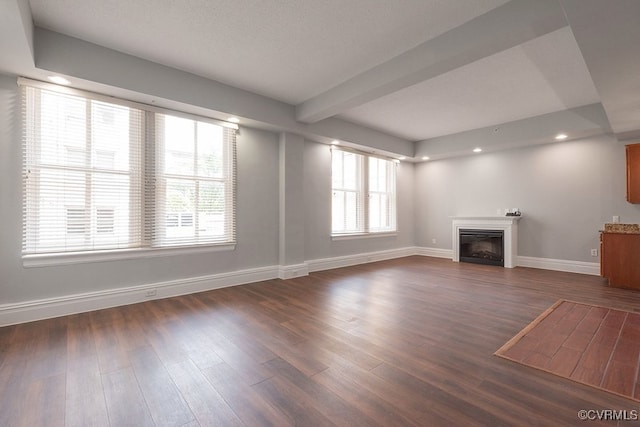 6 N 6th St Unit U3C, Richmond, VA 23219 - unfurnished living room featuring baseboards, a glass covered fireplace, dark wood-style flooring, beamed ceiling, and recessed lighting