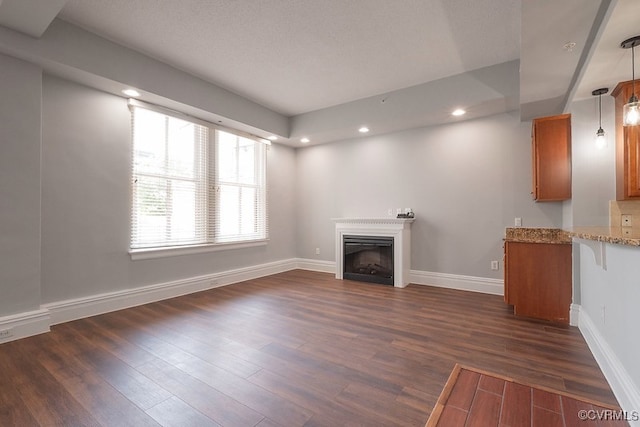 6 N 6th St Unit U3C, Richmond, VA 23219 - unfurnished living room featuring a fireplace, dark wood-style floors, baseboards, and recessed lighting