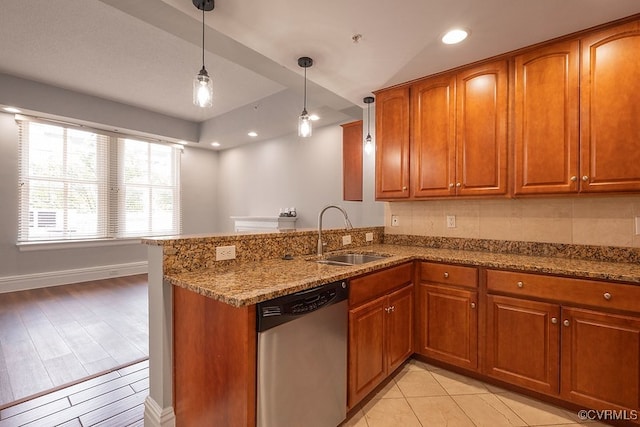 6 N 6th St Unit U3C, Richmond, VA 23219 - kitchen featuring dishwasher, a sink, brown cabinets, stone countertops, and a peninsula