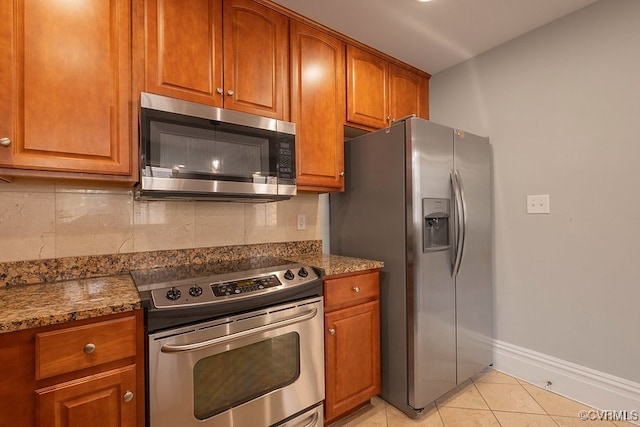 6 N 6th St Unit U3C, Richmond, VA 23219 - kitchen featuring stainless steel appliances, brown cabinetry, and backsplash