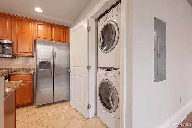 6 N 6th St Unit U3C, Richmond, VA 23219 - laundry room featuring stacked washer / dryer, electric panel, light tile patterned flooring, and recessed lighting