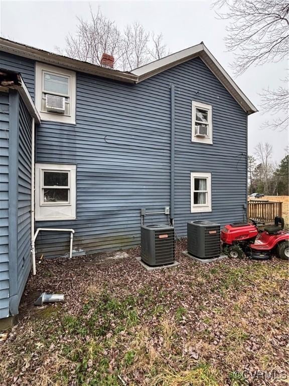 23315 King William Rd, West Point, VA 23181 - view of home's exterior featuring central air condition unit, a chimney, and cooling unit
