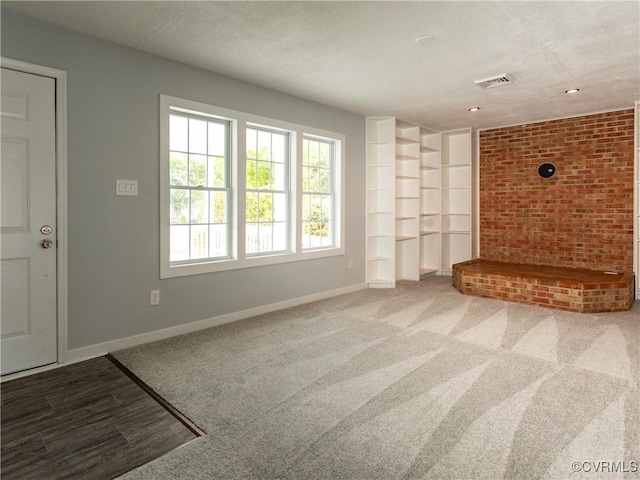 5810 Gunsight Ct, North Chesterfield, VA 23237 - unfurnished living room featuring baseboards, carpet, and brick wall