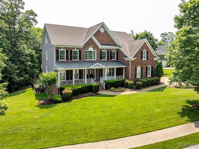 4307 Wilcot Dr, Midlothian, VA 23113 - view of front facade featuring covered porch, a front yard, brick siding, a standing seam roof, and roof with shingles