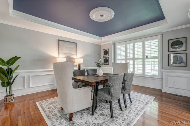 4307 Wilcot Dr, Midlothian, VA 23113 - dining space with a tray ceiling, crown molding, wood finished floors, wainscoting, and a decorative wall