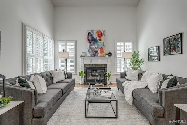 4307 Wilcot Dr, Midlothian, VA 23113 - living room featuring plenty of natural light, a towering ceiling, a fireplace, and wood finished floors