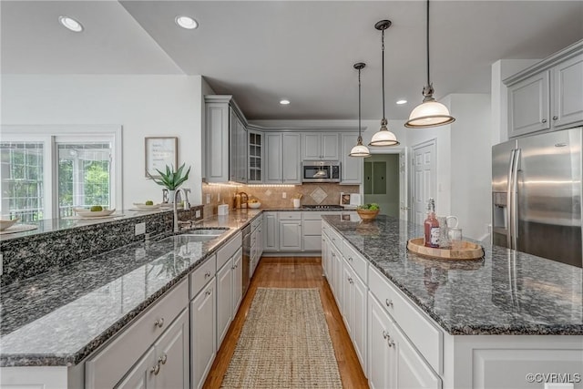 4307 Wilcot Dr, Midlothian, VA 23113 - kitchen featuring appliances with stainless steel finishes, a sink, a kitchen island, gray cabinets, and light wood-style floors