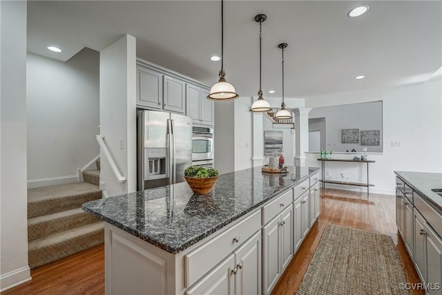 4307 Wilcot Dr, Midlothian, VA 23113 - kitchen with appliances with stainless steel finishes, gray cabinetry, dark wood-type flooring, a kitchen island, and recessed lighting