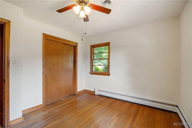 4212 Randolph Rd, North Chesterfield, VA 23236 - unfurnished bedroom featuring a baseboard heating unit, light wood-style flooring, a closet, baseboard heating, and a ceiling fan