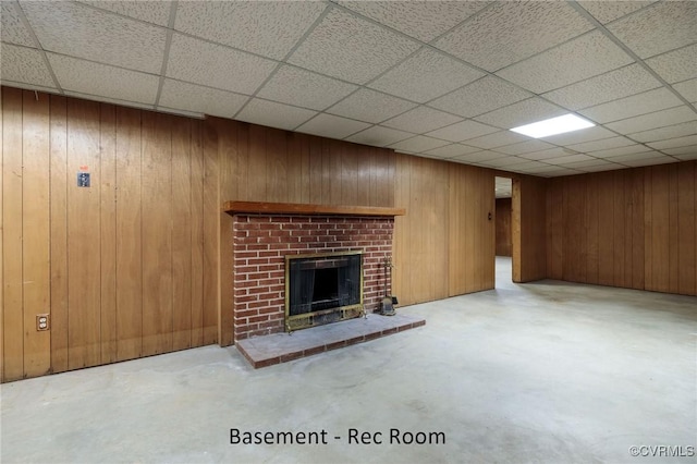 4212 Randolph Rd, North Chesterfield, VA 23236 - unfurnished living room featuring concrete flooring, a fireplace, a drop ceiling, and wood walls