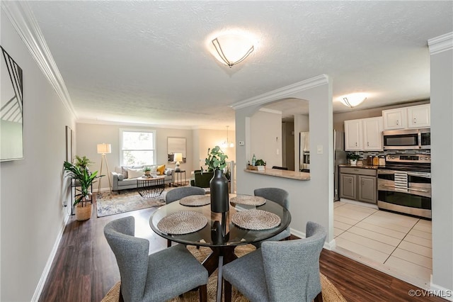 6406 Lothaire Ct, North Chesterfield, VA 23234 - dining area with ornamental molding, baseboards, light wood-type flooring, and arched walkways