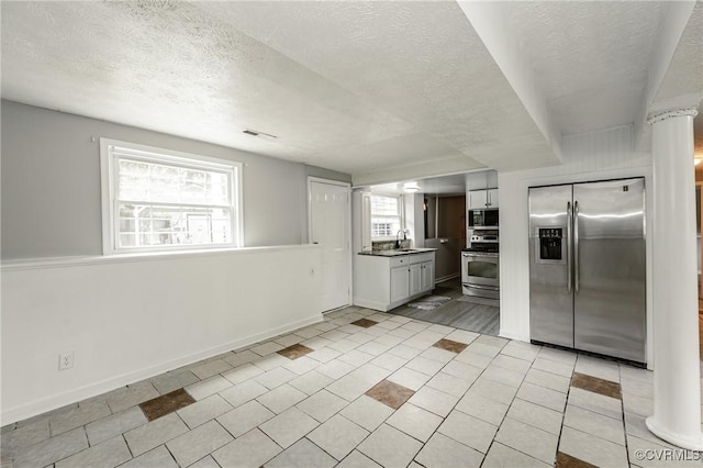 6406 Lothaire Ct, North Chesterfield, VA 23234 - kitchen with appliances with stainless steel finishes, a textured ceiling, baseboards, light tile patterned floors, and a sink