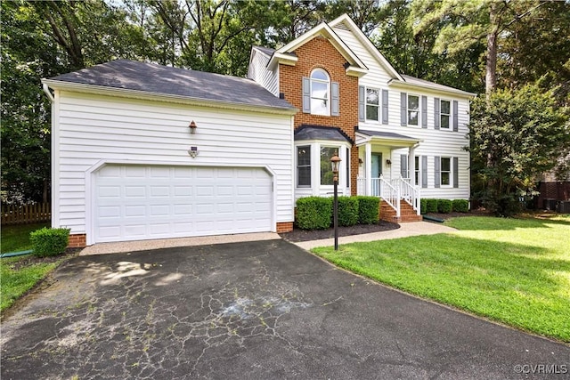 12410 Creek Mill Ct, Glen Allen, VA 23059 - view of front of property with asphalt driveway, a front yard, a garage, and view of wooded area