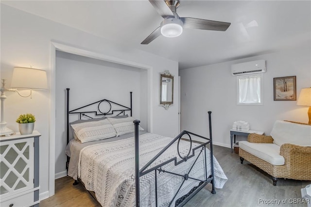 1083 Ottoman Ferry Rd, Mollusk, VA 22503 - bedroom with a wall mounted air conditioner, wood finished floors, and a ceiling fan