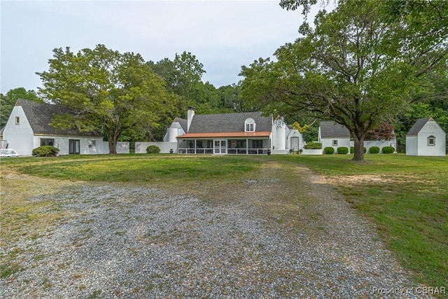 1083 Ottoman Ferry Rd, Mollusk, VA 22503 - view of front of home with a front yard, driveway, and a chimney