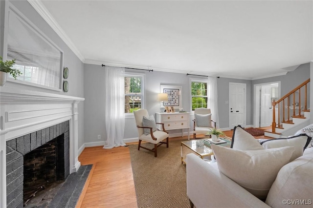 1004 Dinwiddie Ave, Henrico, VA 23229 - living room with a fireplace with flush hearth, crown molding, wood finished floors, stairway, and baseboards