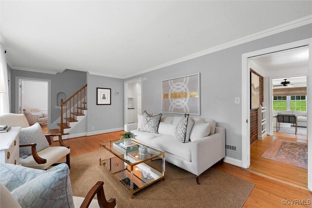 1004 Dinwiddie Ave, Henrico, VA 23229 - living room featuring wood finished floors, ornamental molding, baseboards, stairs, and a ceiling fan