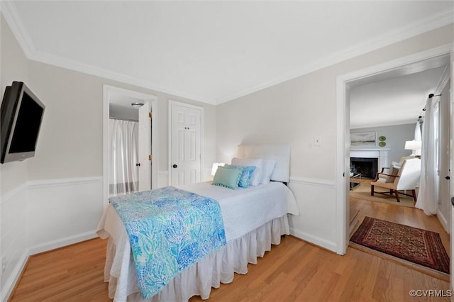 1004 Dinwiddie Ave, Henrico, VA 23229 - bedroom with light wood-style floors, a fireplace, ornamental molding, and a closet