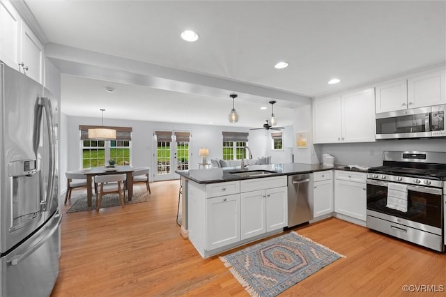 1004 Dinwiddie Ave, Henrico, VA 23229 - kitchen featuring stainless steel appliances, a sink, a peninsula, white cabinets, and recessed lighting