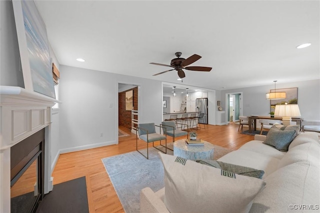 1004 Dinwiddie Ave, Henrico, VA 23229 - living area featuring a fireplace with flush hearth, ceiling fan, wood finished floors, baseboards, and recessed lighting