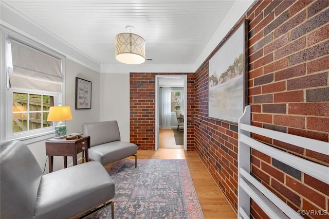 1004 Dinwiddie Ave, Henrico, VA 23229 - hallway with brick wall, light wood-type flooring, and crown molding