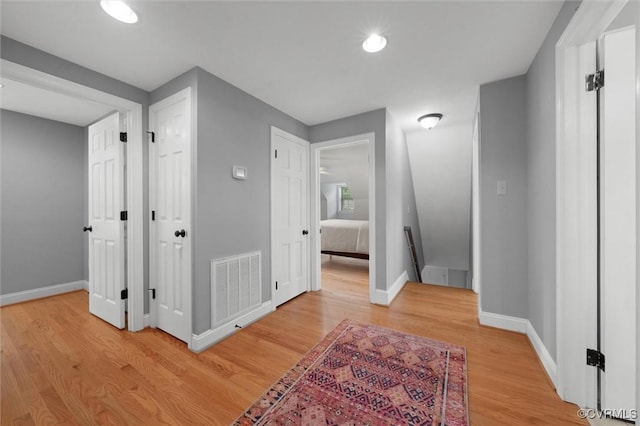 1004 Dinwiddie Ave, Henrico, VA 23229 - hall featuring an upstairs landing, light wood-style flooring, baseboards, and recessed lighting