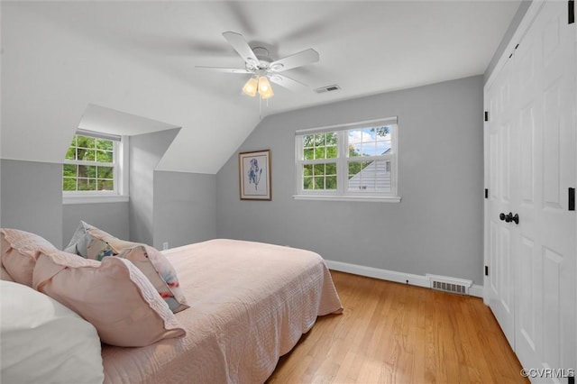 1004 Dinwiddie Ave, Henrico, VA 23229 - bedroom with multiple windows, light wood finished floors, lofted ceiling, a closet, and baseboards