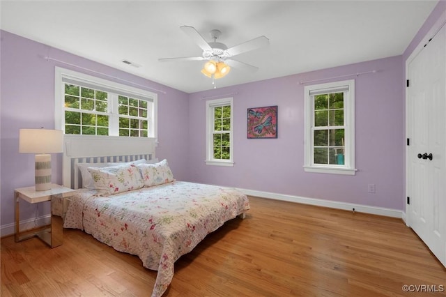 1004 Dinwiddie Ave, Henrico, VA 23229 - bedroom with baseboards, light wood-type flooring, a closet, and ceiling fan
