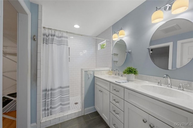 1004 Dinwiddie Ave, Henrico, VA 23229 - bathroom with tiled shower, double vanity, a walk in closet, recessed lighting, and tile patterned floors