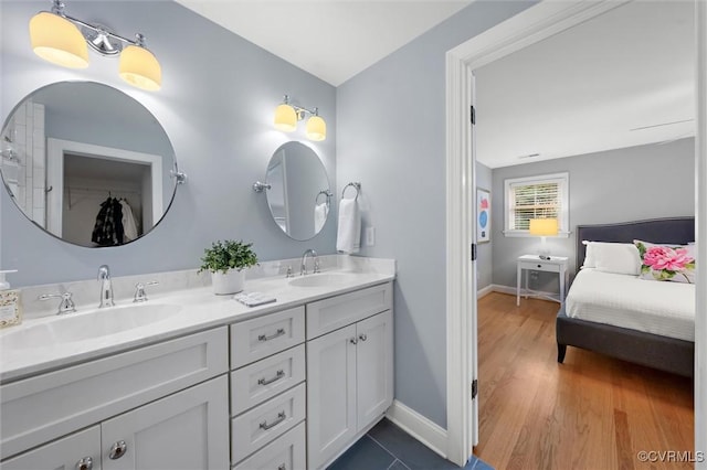 1004 Dinwiddie Ave, Henrico, VA 23229 - full bathroom featuring double vanity, baseboards, and wood finished floors