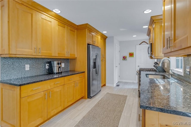 1222 Hull Harbor Rd, Heathsville, VA 22473 - kitchen with appliances with stainless steel finishes, backsplash, dark stone countertops, recessed lighting, and brown cabinets