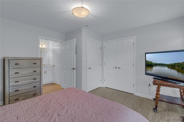 1222 Hull Harbor Rd, Heathsville, VA 22473 - bedroom featuring light wood-type flooring, connected bathroom, and a closet