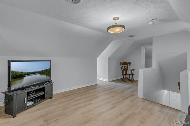 1222 Hull Harbor Rd, Heathsville, VA 22473 - additional living space with vaulted ceiling, wood finished floors, and a textured ceiling