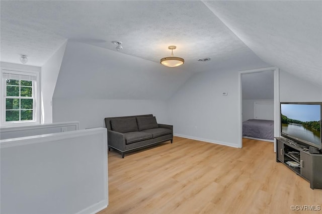 1222 Hull Harbor Rd, Heathsville, VA 22473 - unfurnished room featuring light wood finished floors, vaulted ceiling, and a textured ceiling
